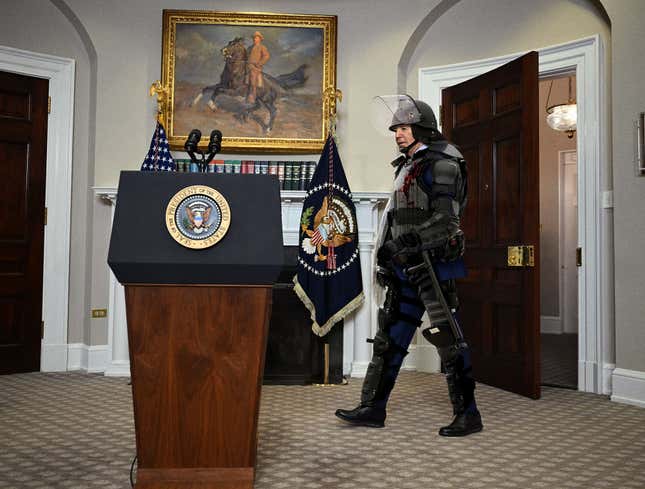 Image for article titled ‘Sorry I’m Late—These Protesters Were A Nightmare,’ Says Blood-Splattered, Riot-Gear-Clad Biden Entering Press Conference